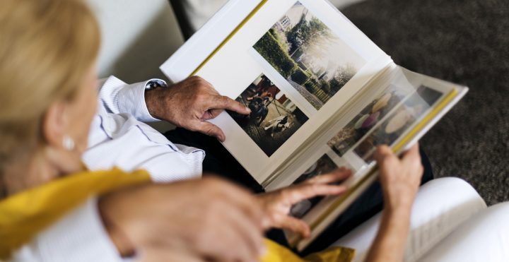 Memory Care Patient looking through scrapbook