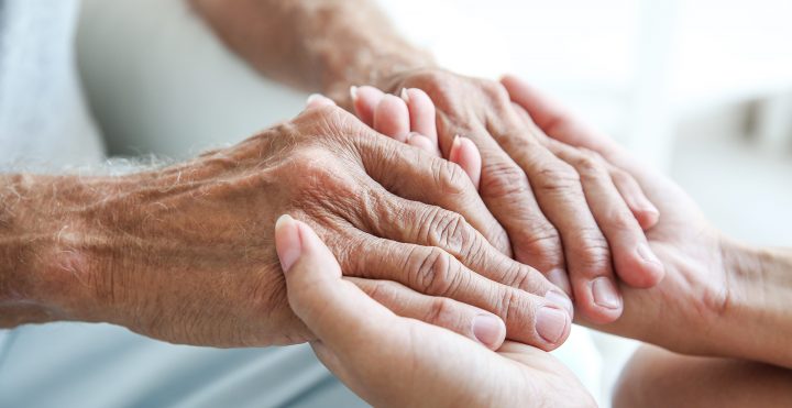 Hands holding with caretakers and residents